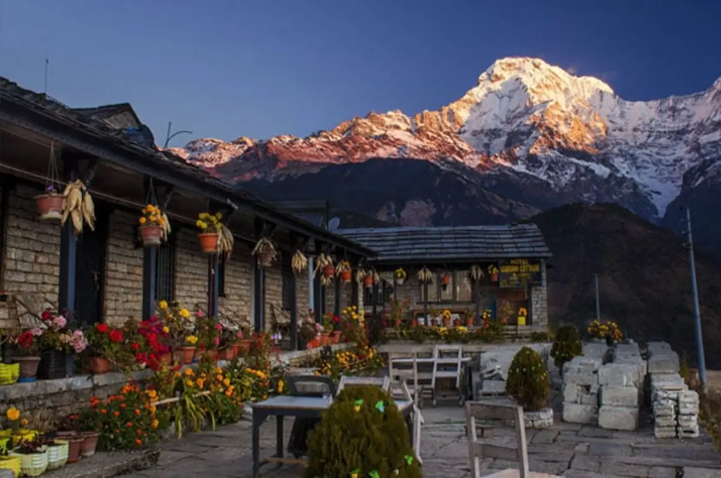 Teahouse accommodation on the Annapurna Circuit trek in Nepal with snow-covered peaks at sunrise