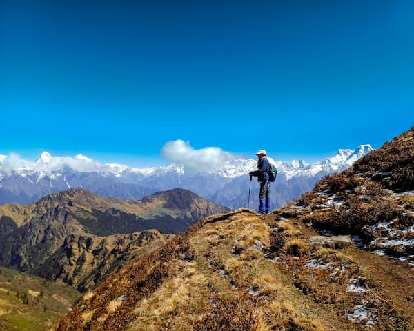 Trekker on a high ridge along the Everest Base Camp trek route in Nepal