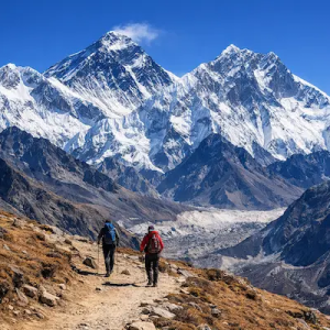 Two trekkers walking the Everest Base Camp trek trail toward snowy Himalayan peaks in Nepal