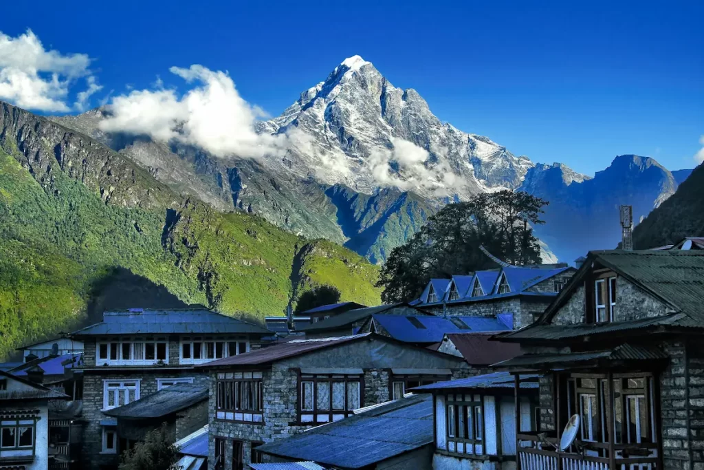Langtang valley trek teahouse village with traditional rooftops and mountain backdrop in Nepal