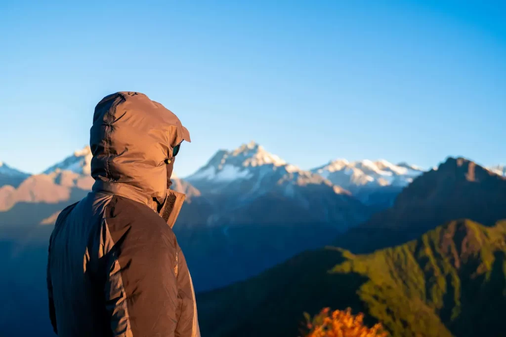 Trekker in Nepal looking toward a snow-covered Himalayan peak